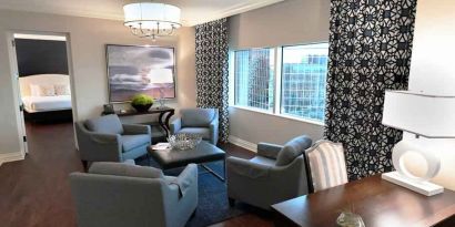 Comfortable and spacious living room with working station in a presidential suite at the Hilton Dallas Lincoln Centre.