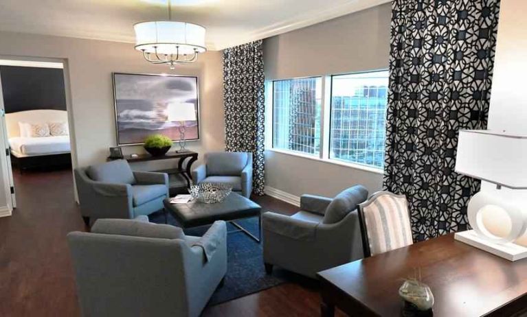 Comfortable and spacious living room with working station in a presidential suite at the Hilton Dallas Lincoln Centre.