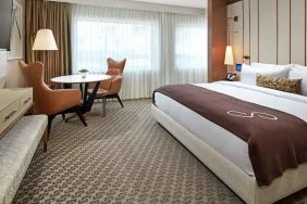 Comfortable king deluxe room with desk and window at the Statler Dallas, Curio Collection by Hilton.