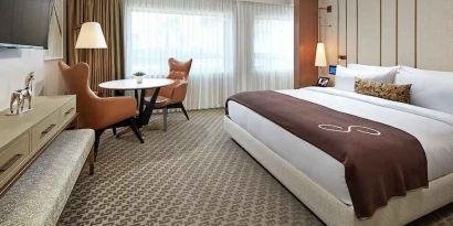 Comfortable king deluxe room with desk and window at the Statler Dallas, Curio Collection by Hilton.