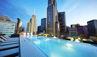 Relaxing outdoor pool with skyline view at the Statler Dallas, Curio Collection by Hilton.