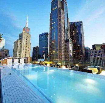 Relaxing outdoor pool with skyline view at the Statler Dallas, Curio Collection by Hilton.