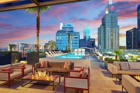 Stunning rooftop with pool and seating area perfect as workspace at the Statler Dallas, Curio Collection by Hilton.