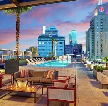 Stunning rooftop with pool and seating area perfect as workspace at the Statler Dallas, Curio Collection by Hilton.