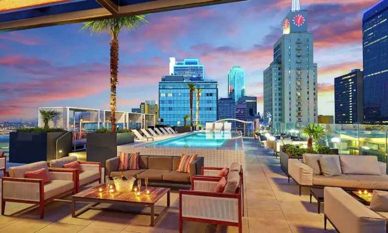 Stunning rooftop with pool and seating area perfect as workspace at the Statler Dallas, Curio Collection by Hilton.