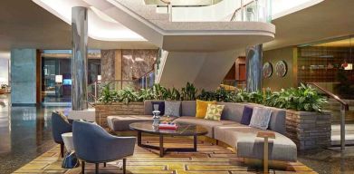 Elegant courtyard lobby perfect as workspace at the Statler Dallas, Curio Collection by Hilton.