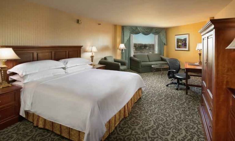 Spacious king room with king size bed, sofa and desk at the DoubleTree by Hilton Lisle-Naperville.