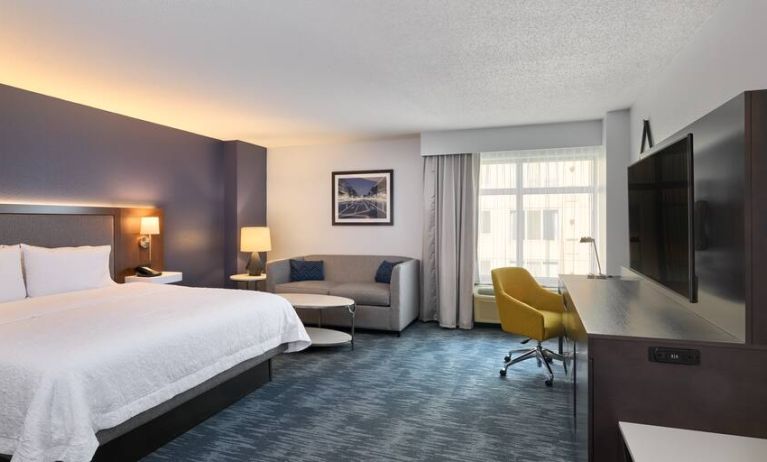 King size bed, sofa and desk in a hotel room at the Hampton Inn Washington-Downtown-Convention Center, DC.