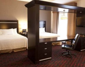 Spacious studio with 2 queen beds, desk area and living room space at the Hampton Inn & Suites Lethbridge, AB,CN