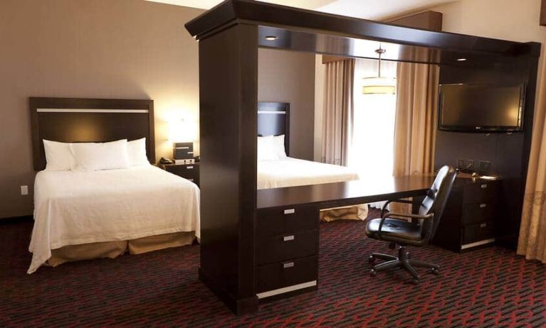 Spacious studio with 2 queen beds, desk area and living room space at the Hampton Inn & Suites Lethbridge, AB,CN