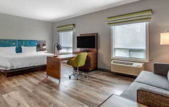 Spacious studio space with 1 king bed, desk, sofabed, couch and tv at the Hampton Inn & Suites by Hilton Edmont