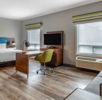 Spacious studio space with 1 king bed, desk, sofabed, couch and tv at the Hampton Inn & Suites by Hilton Edmont