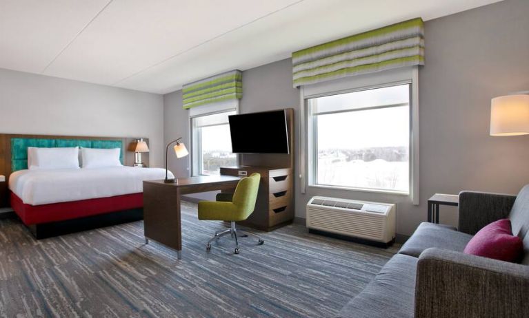 Spacious King suite with 1 king bed,couch, desk area and living room space at the Hampton Inn & Suites Outtawa West