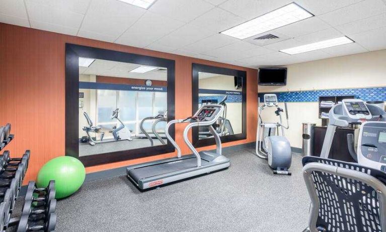 Fitness center with treadmills and weights at the Hampton Inn & Suites West Little Rock.