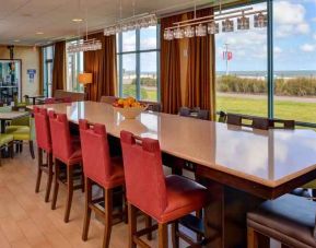 Stylish dining area perfect as workspace at the Hampton Inn Virginia Beach.