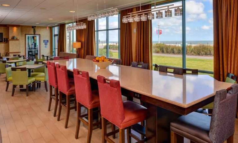 Stylish dining area perfect as workspace at the Hampton Inn Virginia Beach.