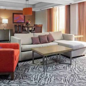 Spacious presidential suite with sofa and lunges at the DoubleTree by Hilton Omaha-Downtown.