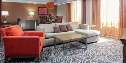 Spacious presidential suite with sofa and lunges at the DoubleTree by Hilton Omaha-Downtown.