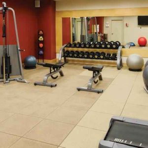 Fitness center with weights and machines at the DoubleTree by Hilton Omaha-Downtown.