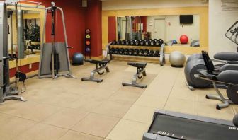 Fitness center with weights and machines at the DoubleTree by Hilton Omaha-Downtown.