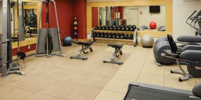 Fitness center with weights and machines at the DoubleTree by Hilton Omaha-Downtown.