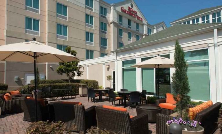 Outdoor patio area with lounges and tables perfect as workspace at the Hilton Garden Inn Tallahassee Central.