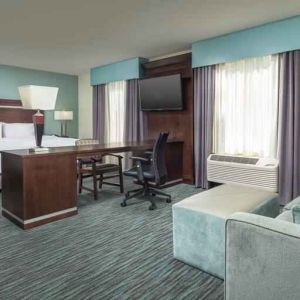 Spacious hotel suite with king size bed and working station at the Hampton Inn & Suites Schererville.