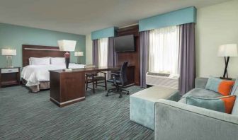 Spacious hotel suite with king size bed and working station at the Hampton Inn & Suites Schererville.