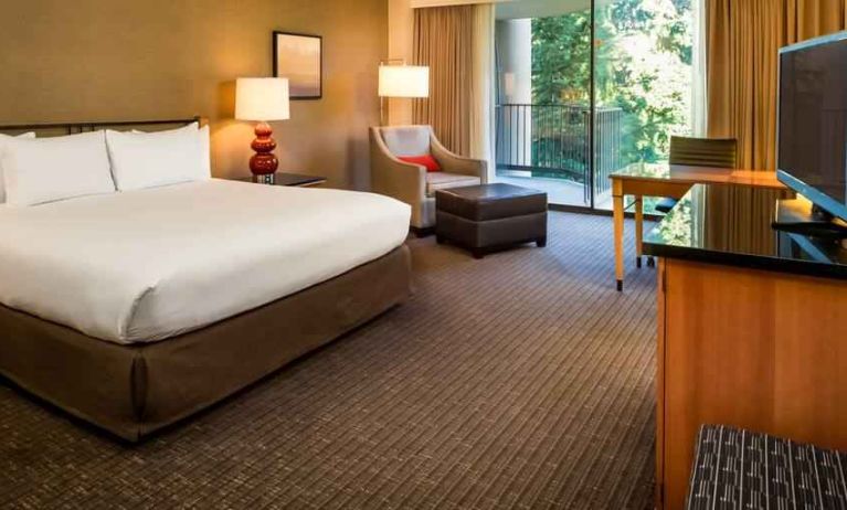 Comfortable king bedroom with balcony at the DoubleTree by Hilton Seattle Airport.