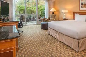 Spacious and comfortable king suite with balcony at the Hilton Seattle Airport & Conference Center.