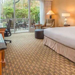 Spacious and comfortable king suite with balcony at the Hilton Seattle Airport & Conference Center.