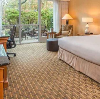 Spacious and comfortable king suite with balcony at the Hilton Seattle Airport & Conference Center.