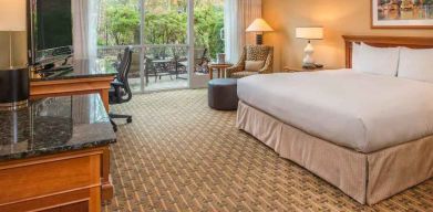 Spacious and comfortable king suite with balcony at the Hilton Seattle Airport & Conference Center.