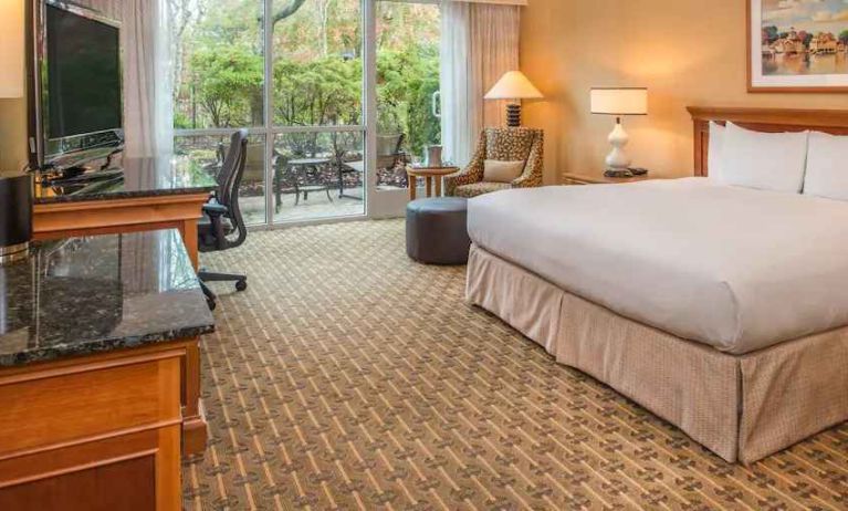 Spacious and comfortable king suite with balcony at the Hilton Seattle Airport & Conference Center.