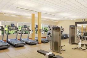 Fitness center with treadmills and machines at the Hilton Seattle Airport & Conference Center.