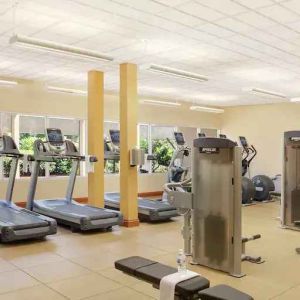 Fitness center with treadmills and machines at the Hilton Seattle Airport & Conference Center.