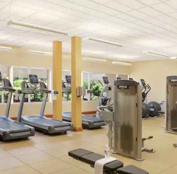 Fitness center with treadmills and machines at the Hilton Seattle Airport & Conference Center.