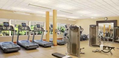 Fitness center with treadmills and machines at the Hilton Seattle Airport & Conference Center.