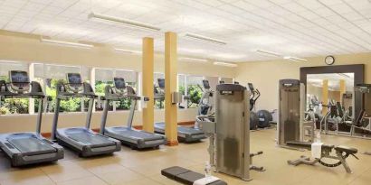 Fitness center with treadmills and machines at the Hilton Seattle Airport & Conference Center.