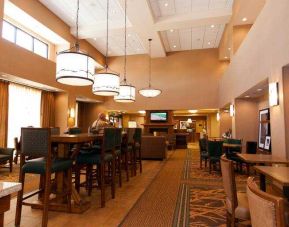 Restaurant area with chairs and tables perfect as workplace at the Hampton Inn & Suites Riverton, WY.