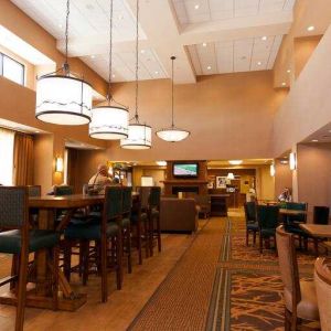 Restaurant area with chairs and tables perfect as workplace at the Hampton Inn & Suites Riverton, WY.