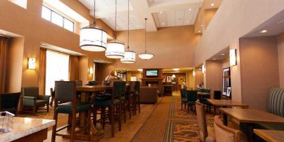 Restaurant area with chairs and tables perfect as workplace at the Hampton Inn & Suites Riverton, WY.