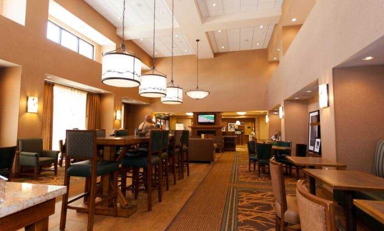 Restaurant area with chairs and tables perfect as workplace at the Hampton Inn & Suites Riverton, WY.