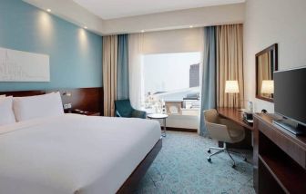 King suite with queen bed, desk, tv, wifi and other amenities at the Hampton by Hilton Dubai al Barsha