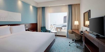 King suite with queen bed, desk, tv, wifi and other amenities at the Hampton by Hilton Dubai al Barsha