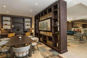 Spacious work lounge area in the lobby with large wooden bookshelves making for cozy partitions.