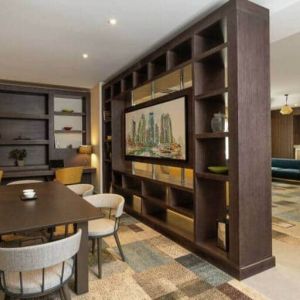 Spacious work lounge area in the lobby with large wooden bookshelves making for cozy partitions.