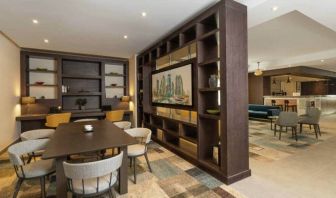 Spacious work lounge area in the lobby with large wooden bookshelves making for cozy partitions.