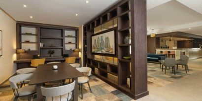 Spacious work lounge area in the lobby with large wooden bookshelves making for cozy partitions.