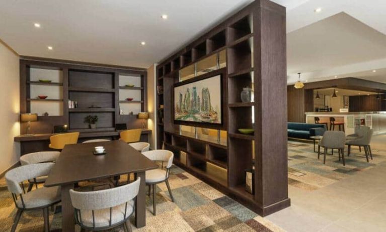 Spacious work lounge area in the lobby with large wooden bookshelves making for cozy partitions.